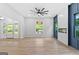 Bright, open-concept living room featuring hardwood floors, a fireplace, and a wall of large windows at 378 Grant Park Se Pl, Atlanta, GA 30315
