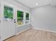 Sunroom with views of the backyard, wood flooring and a glass panel door at 378 Grant Park Se Pl, Atlanta, GA 30315