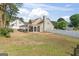 Lovely backyard featuring a covered patio, a white fence, and beautiful landscaping at 3941 Kings Pl, Ellenwood, GA 30294