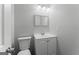 Neutral-toned half bathroom featuring a toilet and sink with modern fixtures at 3941 Kings Pl, Ellenwood, GA 30294