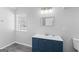 Bathroom with blue vanity, chrome fixtures, and updated vinyl floors provides comfort at 3941 Kings Pl, Ellenwood, GA 30294