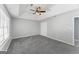 Bedroom offers soft gray carpet, ample natural light, and neutral tones at 3941 Kings Pl, Ellenwood, GA 30294
