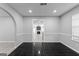 Dining room featuring black tile floors, a large window, and views into the living room and kitchen at 3941 Kings Pl, Ellenwood, GA 30294
