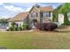 Well maintained two-story home with a beautifully landscaped front yard at 3941 Kings Pl, Ellenwood, GA 30294