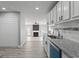 Open concept kitchen with white cabinets, granite counters, and a view into the living room with fireplace at 3941 Kings Pl, Ellenwood, GA 30294
