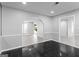 Open living area with black tile flooring and arched doorway, providing a bright and airy feel at 3941 Kings Pl, Ellenwood, GA 30294