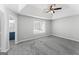 Main bedroom featuring gray carpet and ensuite bathroom offers comfort and style at 3941 Kings Pl, Ellenwood, GA 30294