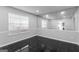 Versatile room featuring a mirrored wall, window with blinds, and black tile flooring at 3941 Kings Pl, Ellenwood, GA 30294