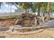 Backyard rock waterfall feature with lush landscaping for relaxation at 3941 Kings Pl, Ellenwood, GA 30294