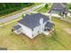 A white home with a large backyard and covered patios, perfect for outdoor entertaining at 152 Creekrise Pl, Palmetto, GA 30268