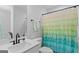 Neutral bathroom features a single sink vanity with a quartz countertop and a rainbow shower curtain at 152 Creekrise Pl, Palmetto, GA 30268