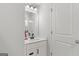 Neutral bathroom features a single sink vanity with a quartz countertop and black hardware at 152 Creekrise Pl, Palmetto, GA 30268
