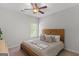 Neutral bedroom featuring a cozy bed, decorative pillows, and a ceiling fan at 152 Creekrise Pl, Palmetto, GA 30268