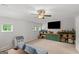 Spacious bonus room features custom built-ins, plush carpet, and modern ceiling fan at 152 Creekrise Pl, Palmetto, GA 30268