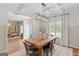 Bright dining room with a rustic table, industrial lighting, coffered ceiling, and large windows for natural light at 152 Creekrise Pl, Palmetto, GA 30268