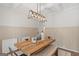 Dining room features a rustic wood table, industrial lighting, and decorative wainscoting creating a stylish space at 152 Creekrise Pl, Palmetto, GA 30268