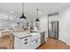 Modern kitchen with a center island, stainless steel appliances, custom cabinets, and open layout perfect for entertaining at 152 Creekrise Pl, Palmetto, GA 30268