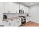 Beautiful kitchen featuring white cabinets, stainless steel appliances, gas range, and subway tile backsplash at 152 Creekrise Pl, Palmetto, GA 30268
