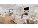 Bright living room with hardwood floors, a fireplace, and an open layout leading to the kitchen at 152 Creekrise Pl, Palmetto, GA 30268