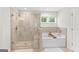 Luxurious main bathroom with tiled shower, separate tub, and windows at 152 Creekrise Pl, Palmetto, GA 30268