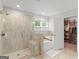 Luxurious main bathroom with tiled shower, separate tub, and walk-in closet at 152 Creekrise Pl, Palmetto, GA 30268