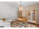 Stylish home office with natural light, built-in bookshelves, comfortable seating, and a modern desk setup at 152 Creekrise Pl, Palmetto, GA 30268