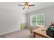 Bright office features a wooden desk, plush carpet, and abundant natural light at 152 Creekrise Pl, Palmetto, GA 30268