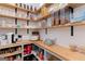 Well-organized pantry with custom wood shelving, ample storage space, and stylish containers to keep items tidy at 152 Creekrise Pl, Palmetto, GA 30268