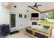 This backyard patio features an outdoor fireplace, mounted TV, and comfortable seating at 152 Creekrise Pl, Palmetto, GA 30268