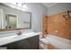 Well-lit bathroom with a bathtub, tiled walls, and large mirror above the vanity at 2548 Kickerillo Se Way, Atlanta, GA 30316