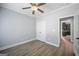 Bedroom featuring wood floors, a ceiling fan, and door access to the main living space at 2548 Kickerillo Se Way, Atlanta, GA 30316