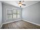 A light-filled bedroom with wood floors, a ceiling fan, and large window for natural light at 2548 Kickerillo Se Way, Atlanta, GA 30316