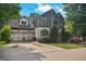 Charming home with a three-car garage, well-manicured lawn, and inviting covered front porch at 2548 Kickerillo Se Way, Atlanta, GA 30316