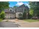 Charming home with a three-car garage, well-manicured lawn, and inviting covered front porch at 2548 Kickerillo Se Way, Atlanta, GA 30316