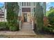 Inviting front entry with stone accents, a dark front door, and lush greenery at 2548 Kickerillo Se Way, Atlanta, GA 30316