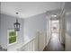 Hallway with hardwood floors, white trim, and a pendant light fixture at 2548 Kickerillo Se Way, Atlanta, GA 30316