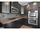 Kitchen boasting stainless steel oven and appliances, black cabinets, and beautiful granite countertop at 2548 Kickerillo Se Way, Atlanta, GA 30316