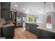 Kitchen with stainless steel appliances, black cabinets, granite countertops, and access to the back deck at 2548 Kickerillo Se Way, Atlanta, GA 30316