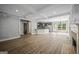Spacious living area with wood floors, modern lighting, and seamless flow to the kitchen at 2548 Kickerillo Se Way, Atlanta, GA 30316
