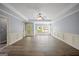 Spacious living room with hardwood floors, chair railing, and natural light from multiple windows at 2548 Kickerillo Se Way, Atlanta, GA 30316