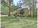 Spacious backyard with lush green lawn and mature trees, perfect for outdoor activities and relaxation at 401 Waterwood Bnd, Peachtree City, GA 30269