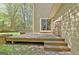Backyard deck, sliding doors and patio on a two story home with green lawn and mature trees at 401 Waterwood Bnd, Peachtree City, GA 30269