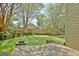 Spacious backyard with mature trees, wooden planters, green lawn and wooden deck at 401 Waterwood Bnd, Peachtree City, GA 30269