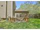 Rear of house with wood deck, stair access, well manicured lawn and privacy fence at 401 Waterwood Bnd, Peachtree City, GA 30269