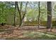 Backyard featuring mature trees and a wooden fence providing privacy and shade at 401 Waterwood Bnd, Peachtree City, GA 30269
