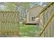 Fenced backyard with deck and green grass at 401 Waterwood Bnd, Peachtree City, GA 30269
