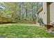 Well maintained backyard with wooden planters, mature trees, green lawn and fenced perimeter at 401 Waterwood Bnd, Peachtree City, GA 30269