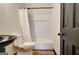 Bathroom featuring white tub/shower combo with white curtain and dark accents at 401 Waterwood Bnd, Peachtree City, GA 30269