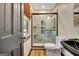 A modern bathroom with a glass-enclosed shower, a toilet, and a black sink at 401 Waterwood Bnd, Peachtree City, GA 30269