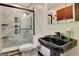 A modern bathroom with a glass-enclosed shower, a toilet, and a black sink at 401 Waterwood Bnd, Peachtree City, GA 30269